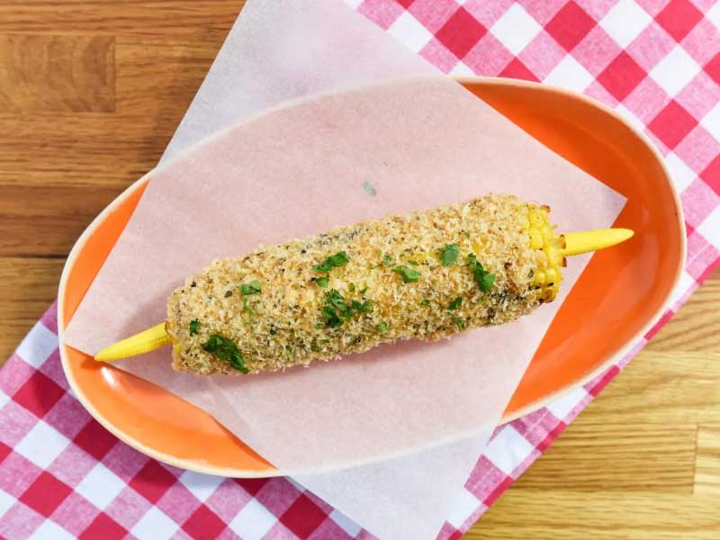 Chipotle mayo with Oregano-Panko grilled corn on plate